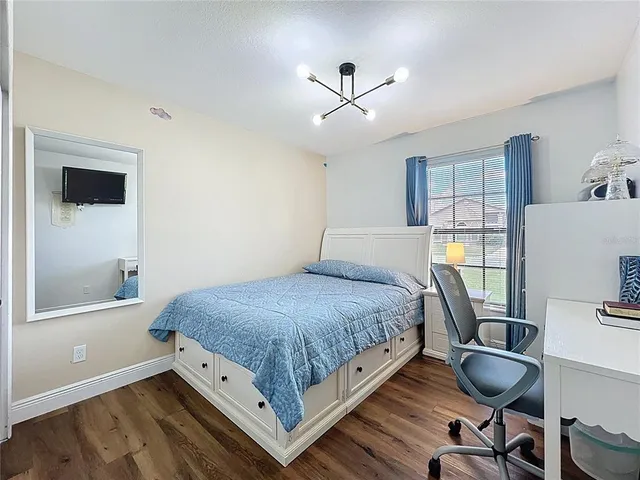 a bedroom with a bed and a chandelier