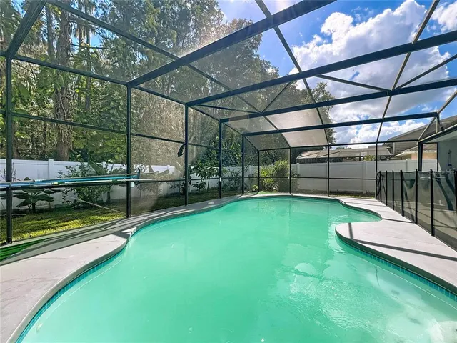 a view of a backyard with swimming pool