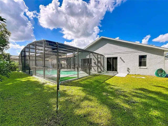 a view of a house with a backyard