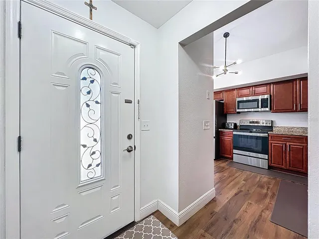 a kitchen with stainless steel appliances granite countertop a refrigerator and a stove top oven