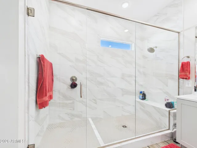 a bedroom with a bed and a book shelf