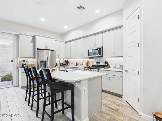 a living room with furniture a flat screen tv and a floor to ceiling window