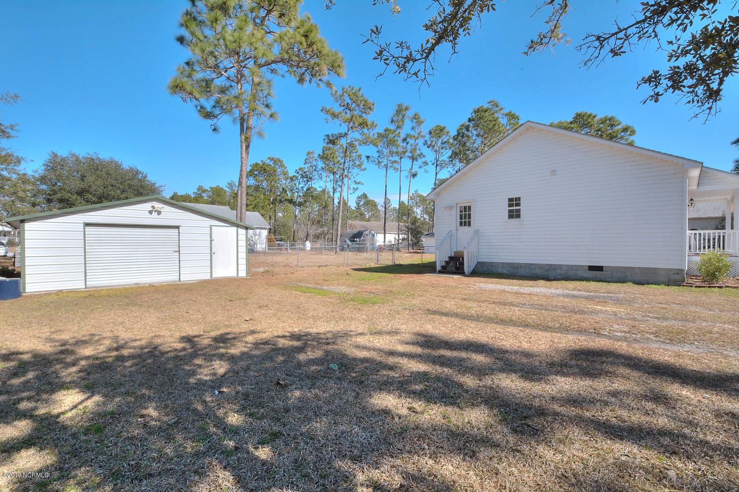 70 Greensboro Road Southport, NC 28461 - Photo 21 of 24 Side of home w 20x20 detached storage