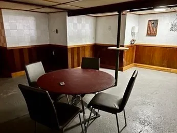 a backyard of a house with table and chairs