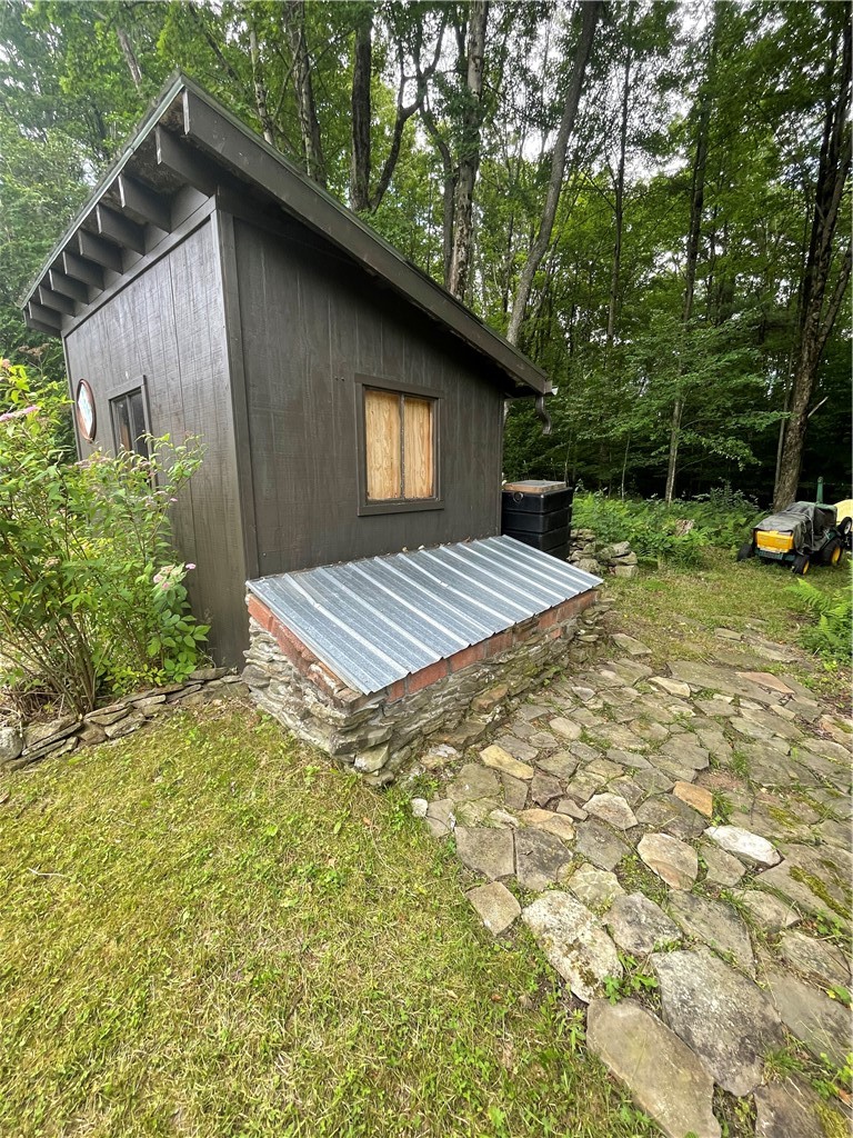 619 Town Line Road German, NY 13801 - Photo 11 of 38 Outbuilding with stone enclosure (vented) which covers generator!