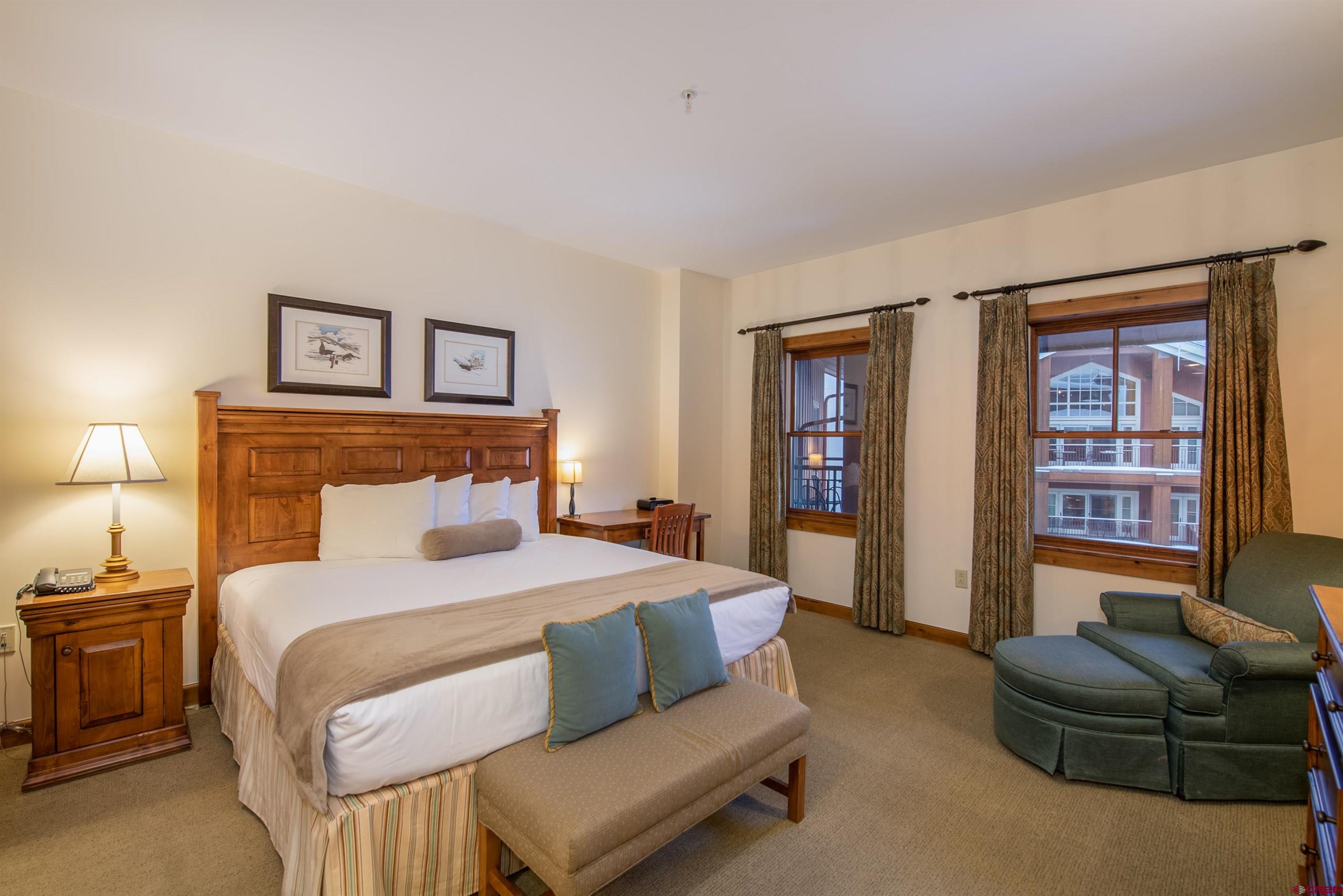 620 Gothic Road, Unit 504 Crested Butte, CO 81225 - Photo 13 of 33 a bedroom with a bed couch and a window