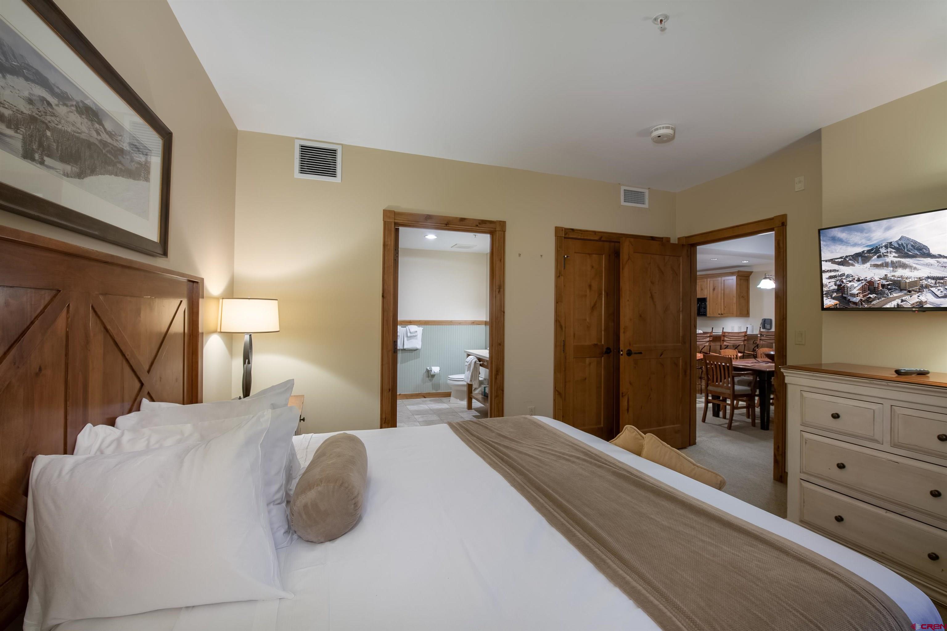 620 Gothic Road, Unit 504 Crested Butte, CO 81225 - Photo 17 of 33 a bedroom with a bed and painting on the wall