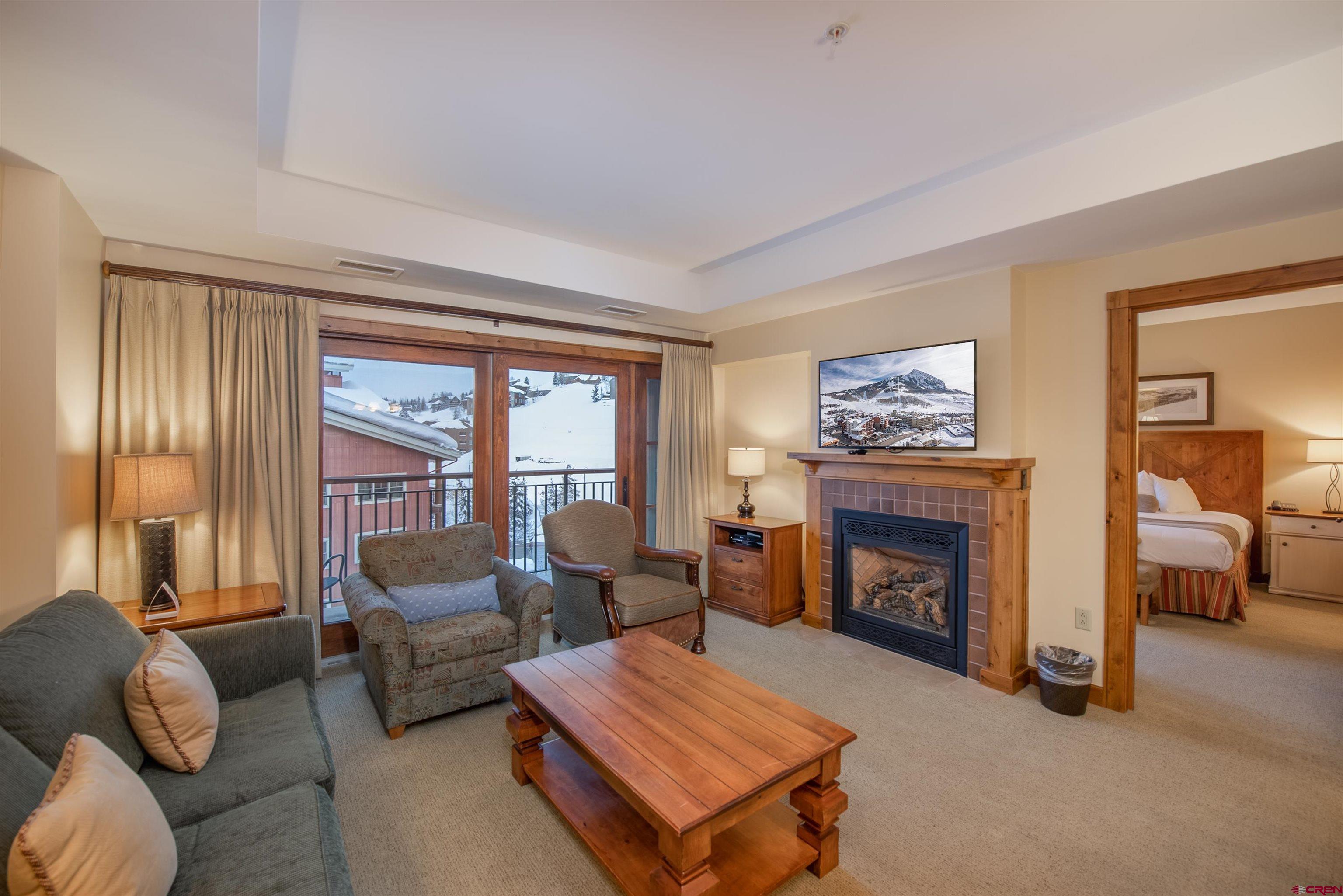 620 Gothic Road, Unit 504 Crested Butte, CO 81225 - Photo 2 of 33 a living room with furniture and a fireplace