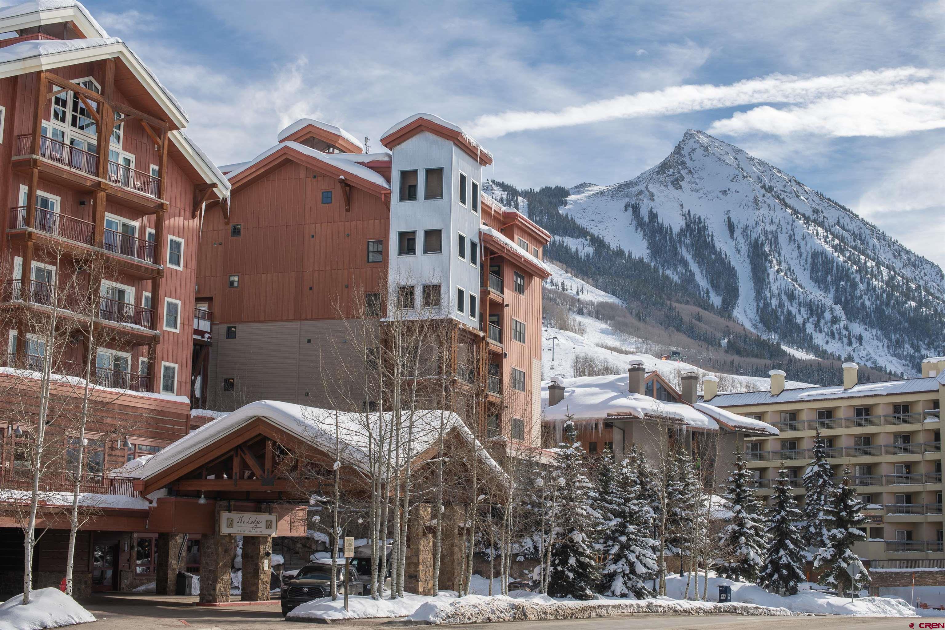 620 Gothic Road, Unit 504 Crested Butte, CO 81225 - Photo 21 of 33 a front view of a building with a yard
