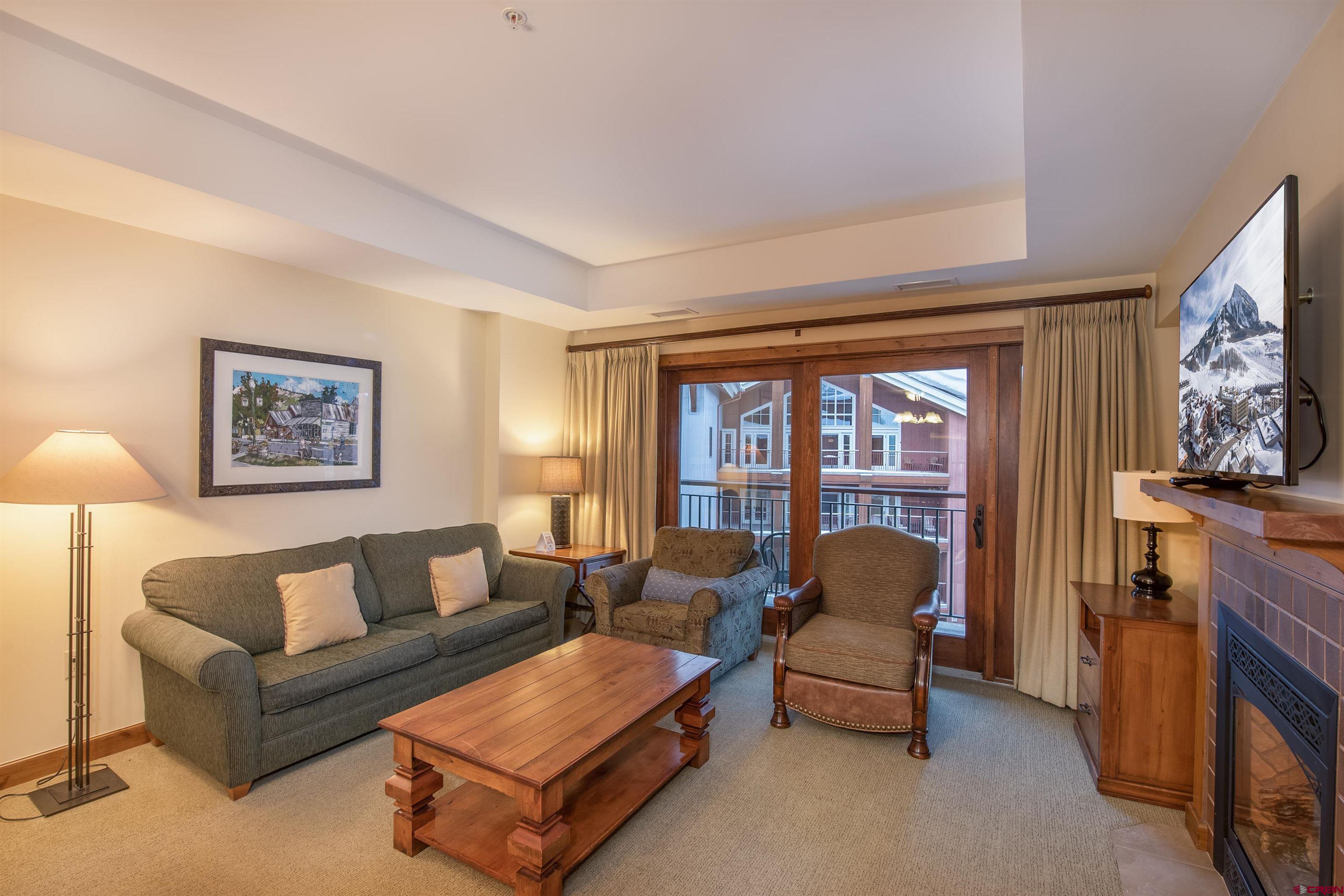 620 Gothic Road, Unit 504 Crested Butte, CO 81225 - Photo 3 of 33 a living room with furniture and a flat screen tv