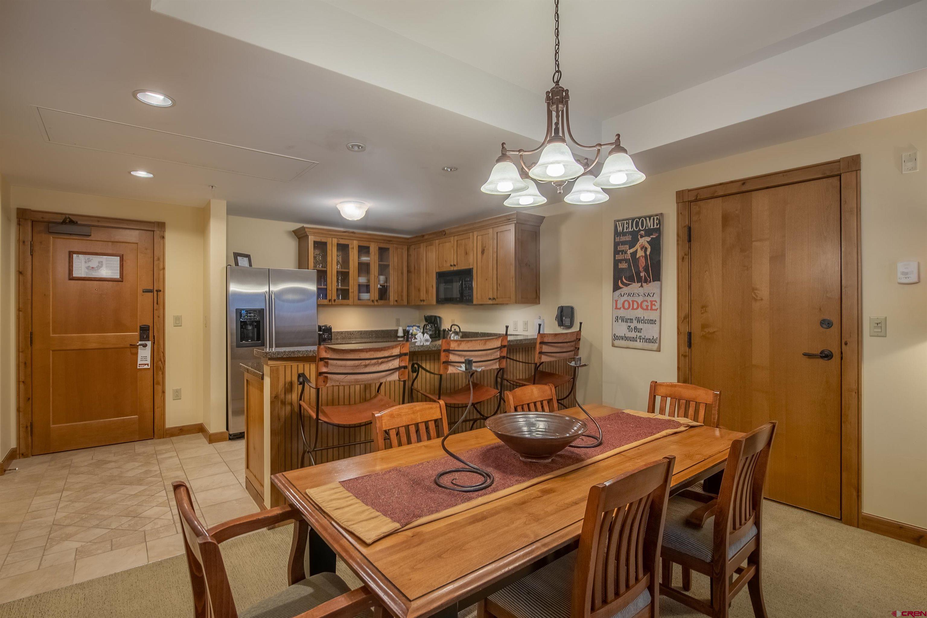 620 Gothic Road, Unit 504 Crested Butte, CO 81225 - Photo 6 of 33 a view of a dining room with furniture and a chandelier