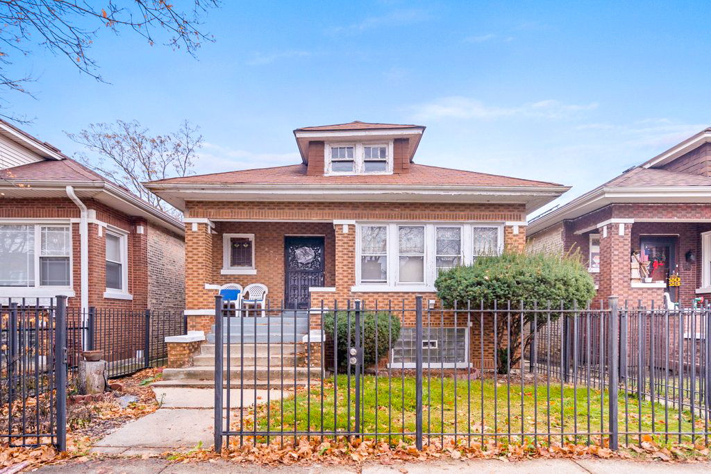 1627 North Long Avenue Chicago, IL 60639 - Photo 1 of 36 a front view of house with a garden