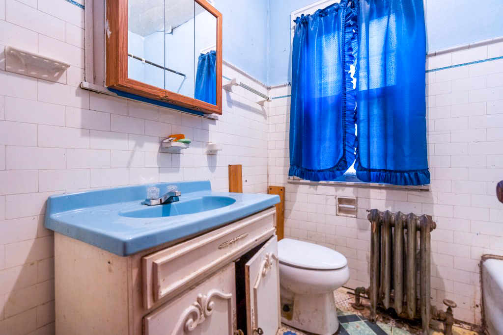 1627 North Long Avenue Chicago, IL 60639 - Photo 11 of 36 a bathroom with a sink a toilet and a mirror