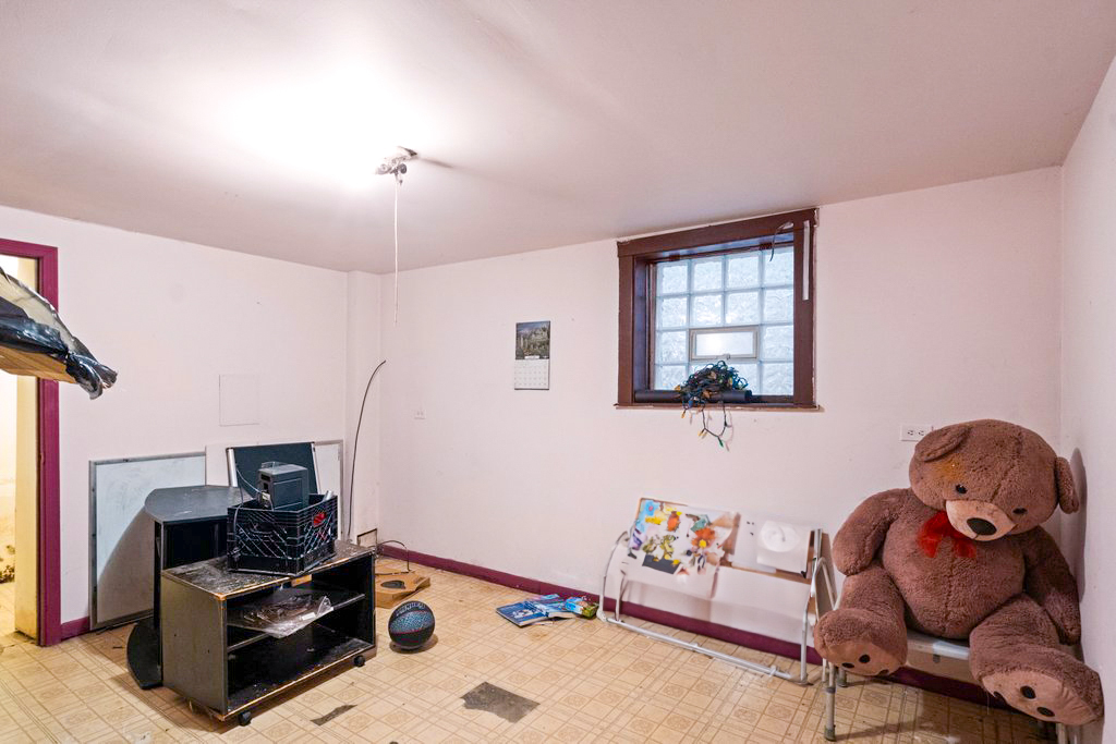 1627 North Long Avenue Chicago, IL 60639 - Photo 16 of 36 a bedroom with furniture and a window