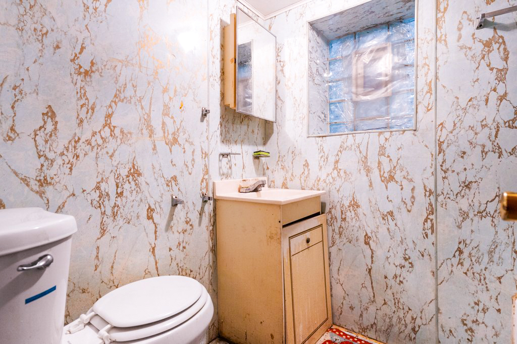 1627 North Long Avenue Chicago, IL 60639 - Photo 25 of 36 a bathroom with a sink toilet and mirror