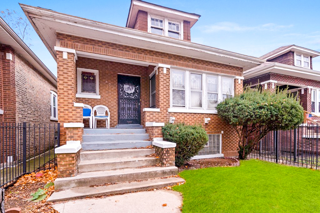 1627 North Long Avenue Chicago, IL 60639 - Photo 3 of 36 a front view of a house with a yard