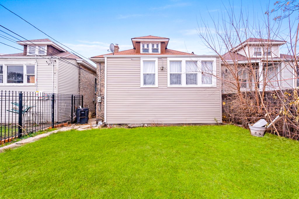 1627 North Long Avenue Chicago, IL 60639 - Photo 31 of 36 a front view of a house with a yard