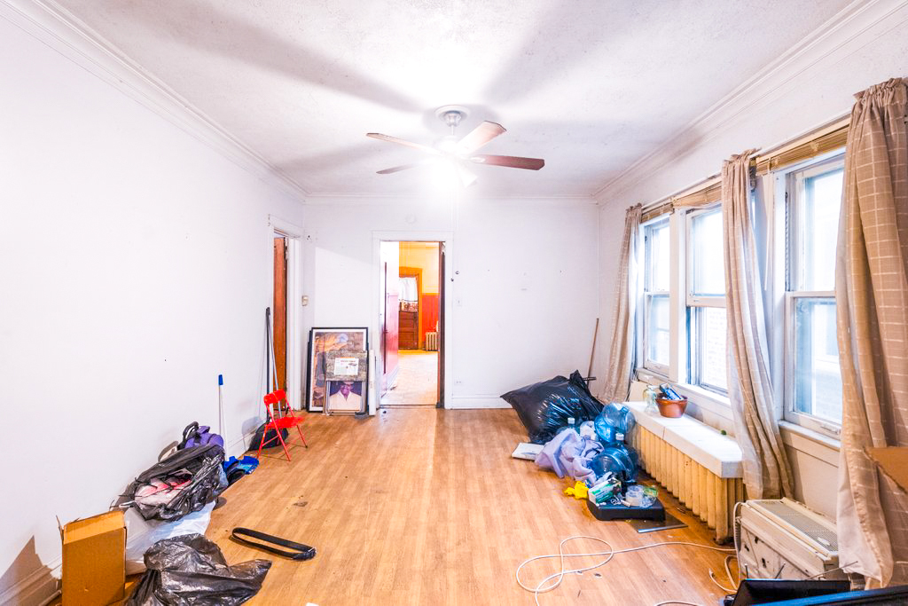 1627 North Long Avenue Chicago, IL 60639 - Photo 7 of 36 a bed room with a bed and a chair