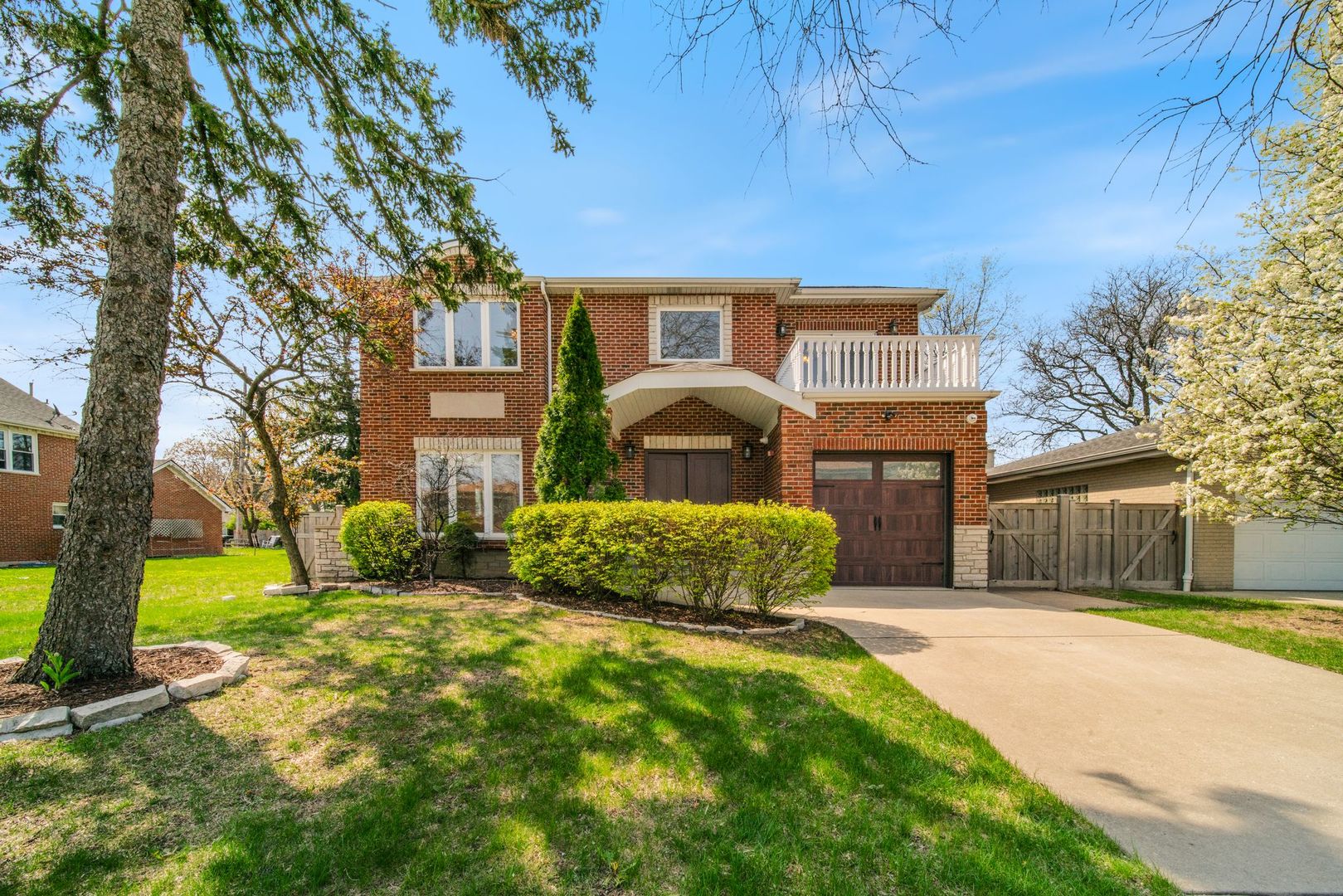 701 Oakton Street Park Ridge, IL 60068 - Photo 1 of 59 a front view of a house with a yard and large tree