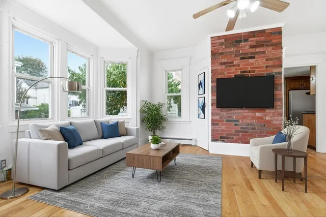a living room with fireplace furniture and a flat screen tv