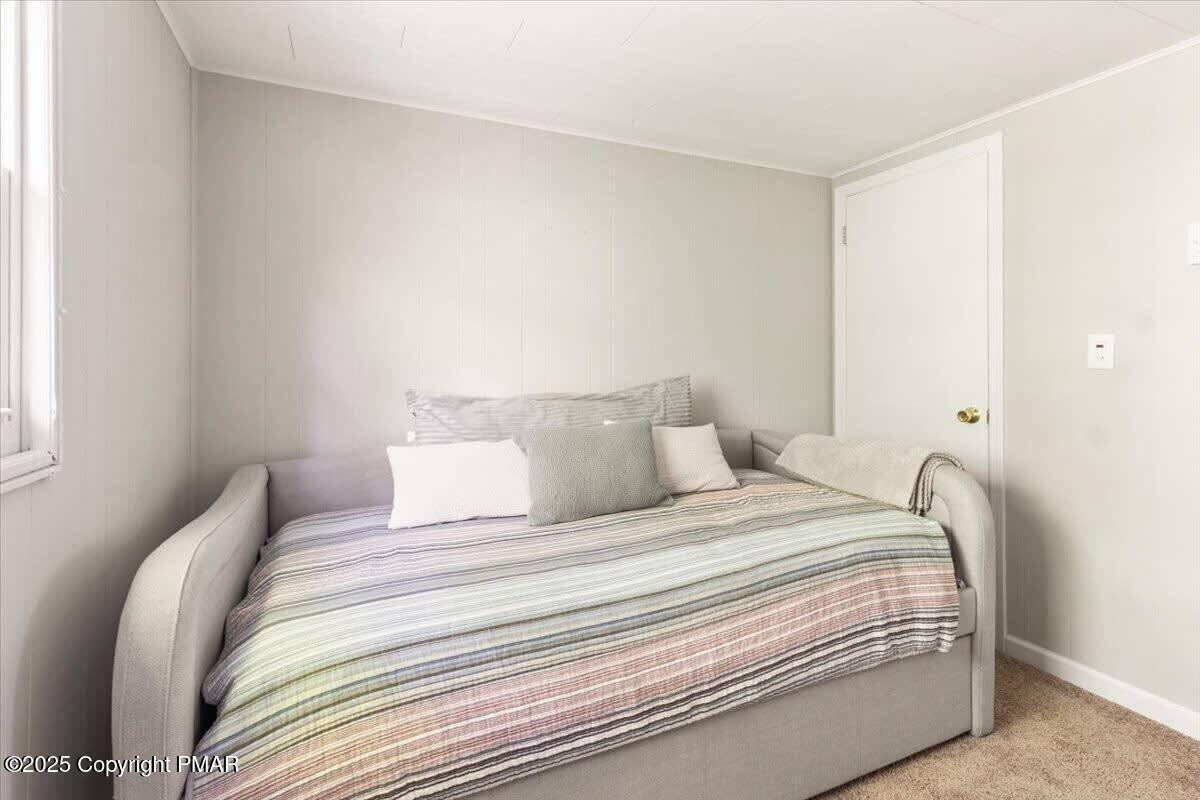 102 Sweet Briar Road Pocono Pines, PA 18350 - Photo 14 of 21 a bedroom with a bed and a night stand