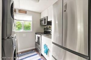 102 Sweet Briar Road Pocono Pines, PA 18350 - Photo 8 of 21 a kitchen with a refrigerator and a stove