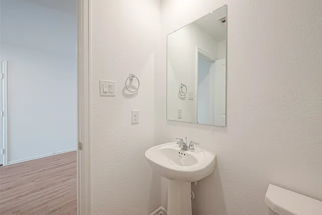 a bathroom with a sink a mirror and toilet
