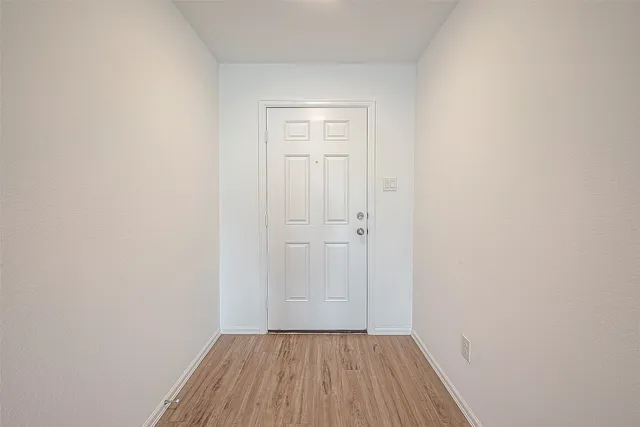 a view of a room with wooden floor