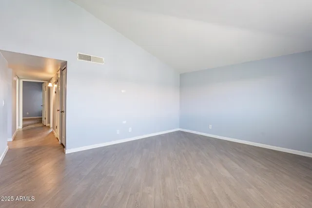 a view of an empty room and wooden floor