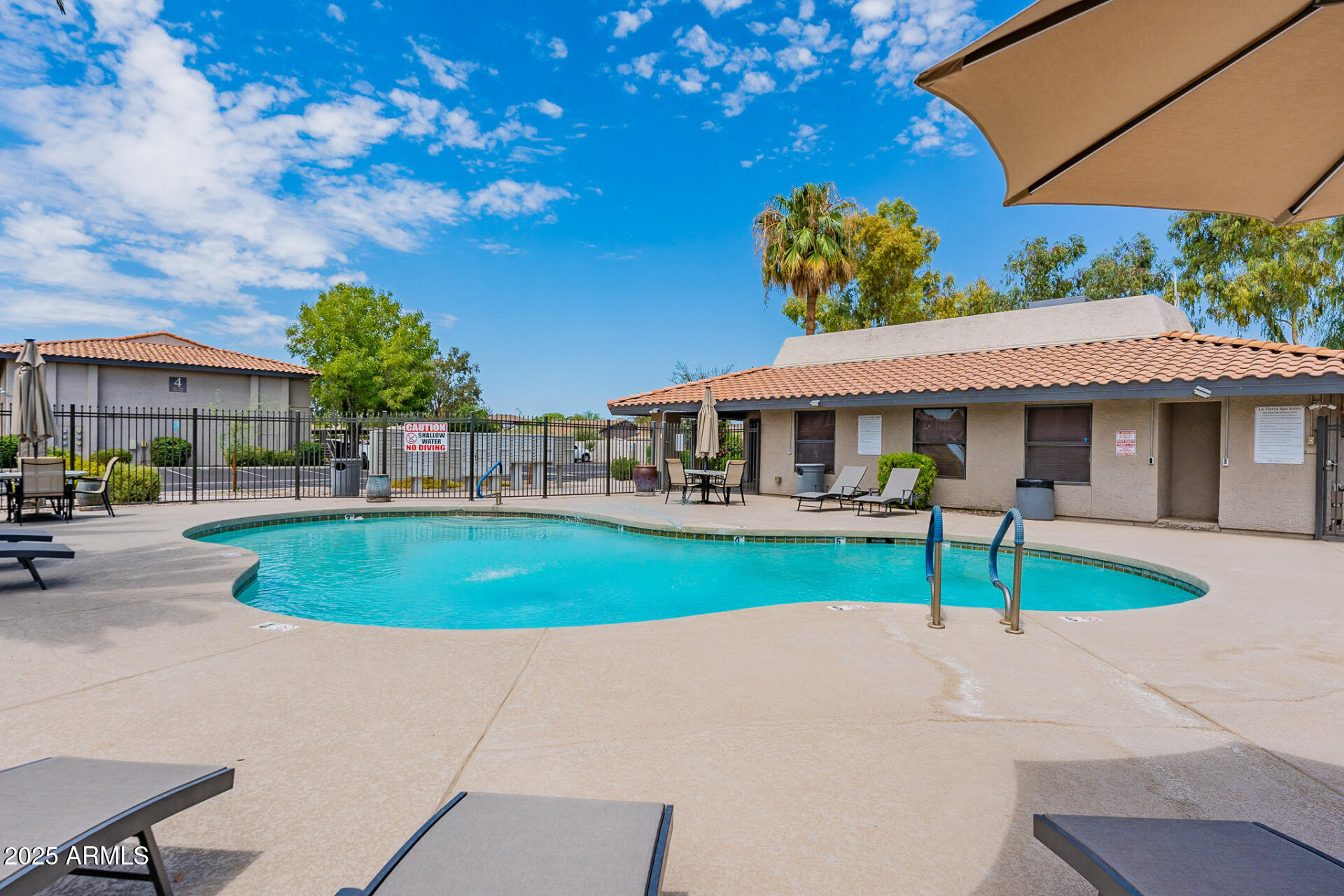 1402 East Guadalupe Road, Unit 207 Tempe, AZ 85283 - Photo 33 of 33 a view of a house with a yard and table under an umbrella