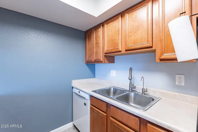 a kitchen with a sink cabinets and a window