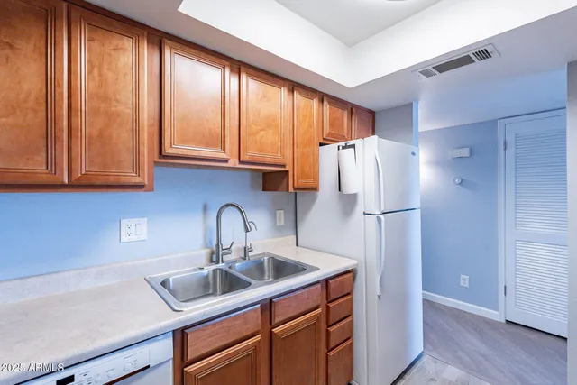 a kitchen with refrigerator a sink and cabinets