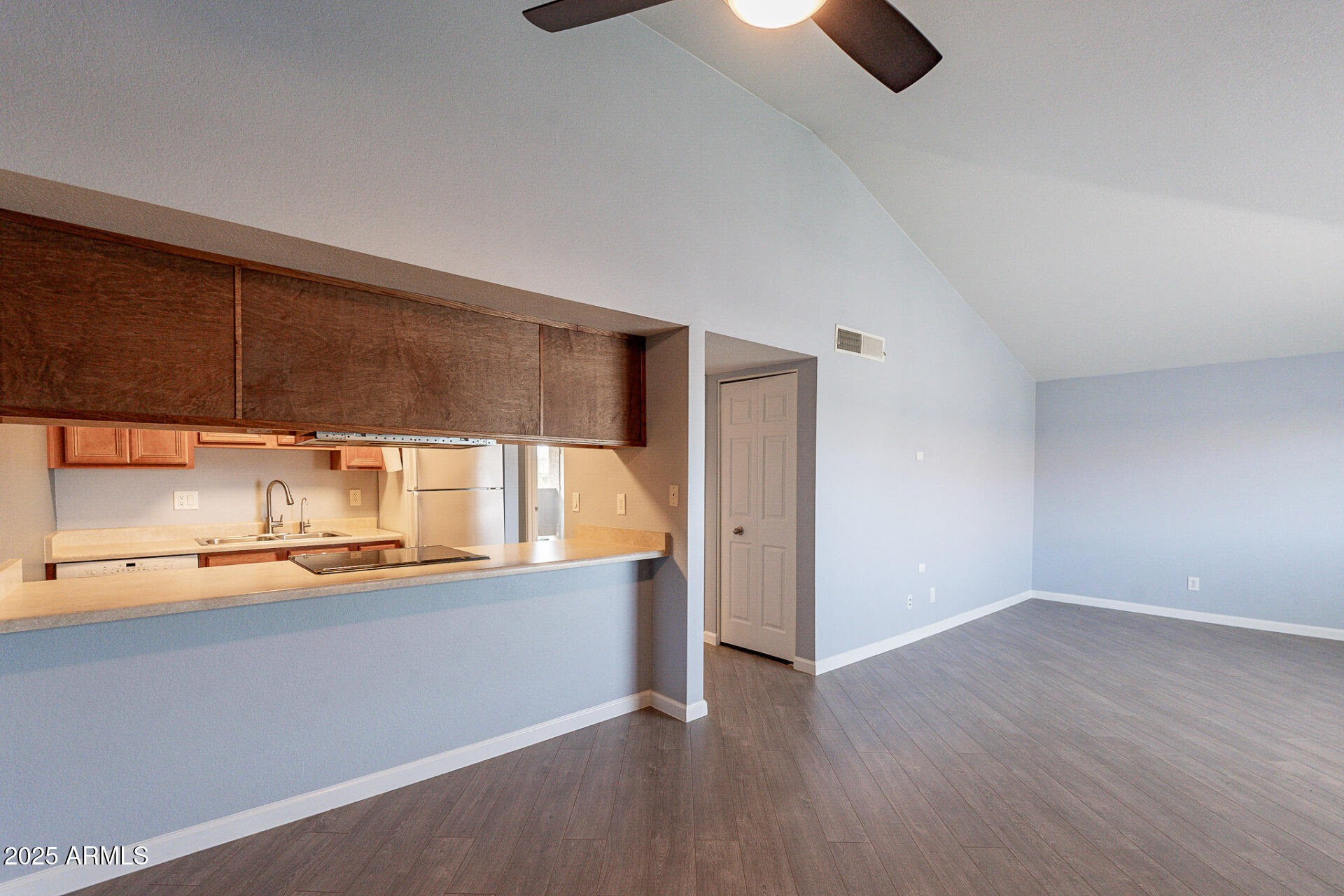 1402 East Guadalupe Road, Unit 207 Tempe, AZ 85283 - Photo 9 of 33 an empty room with a kitchen view
