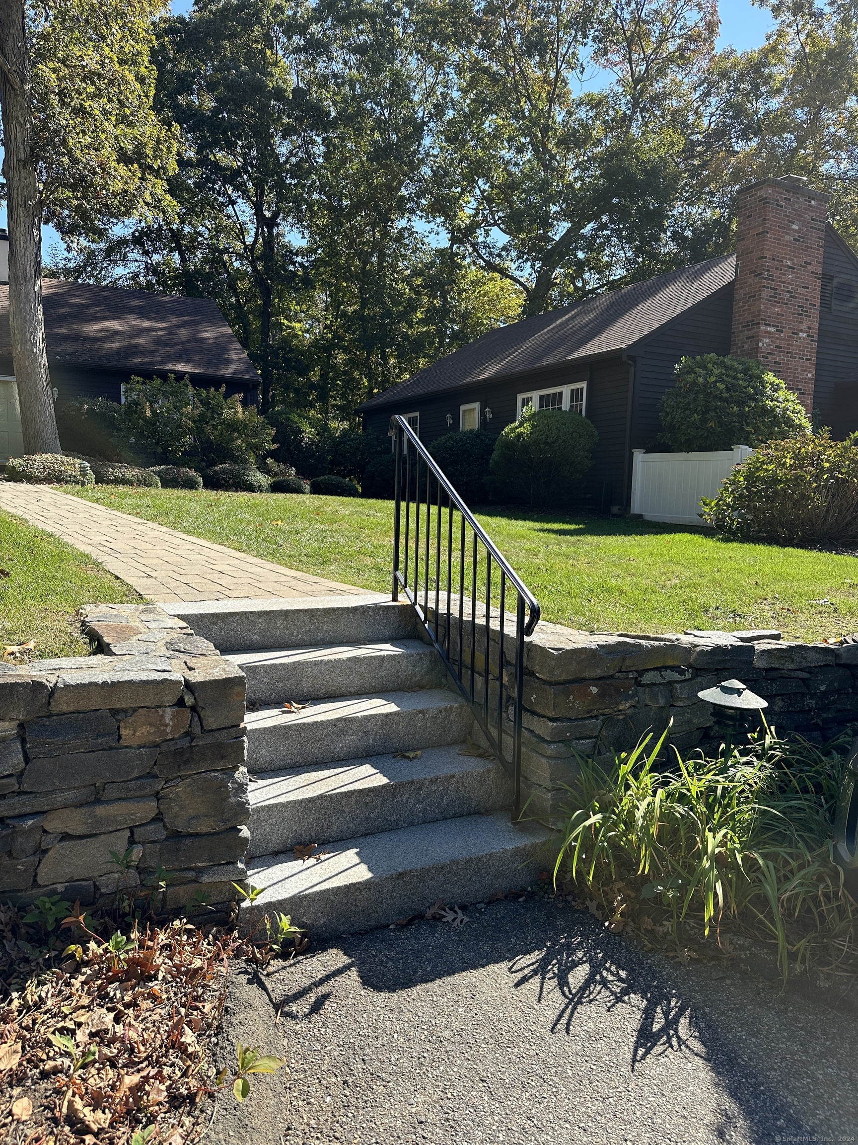 7 Wilshire Road, Unit 7 Madison, CT 06443 - Photo 2 of 22 Stair leading from parking area to walkway leading to unit.