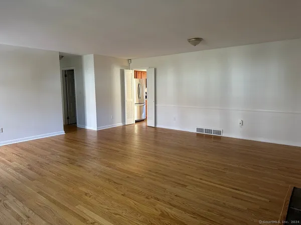 a view of a room with wooden floor