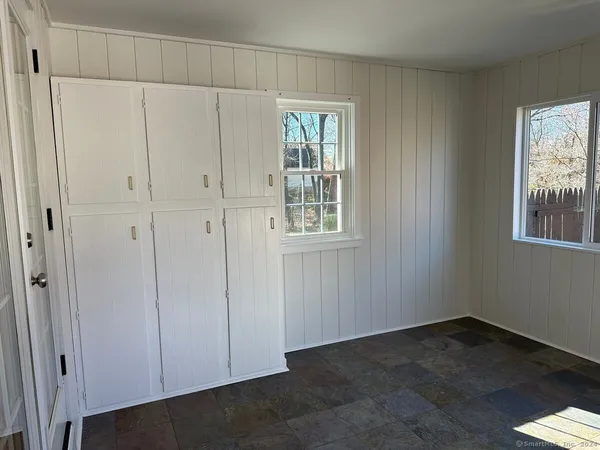 a view of an empty room with closet area