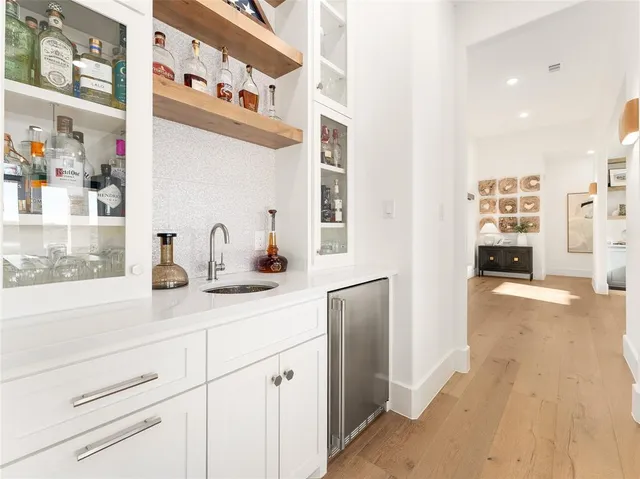 a hallway with cabinets and window