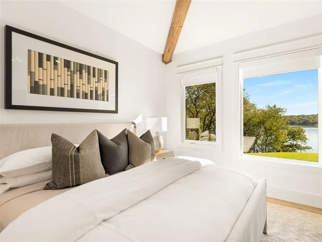 a bedroom with a bed and a large window