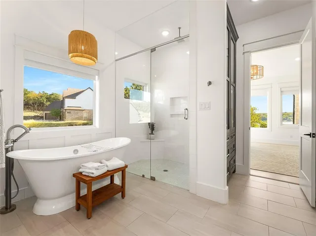 a spacious bathroom with a bathtub and a shower