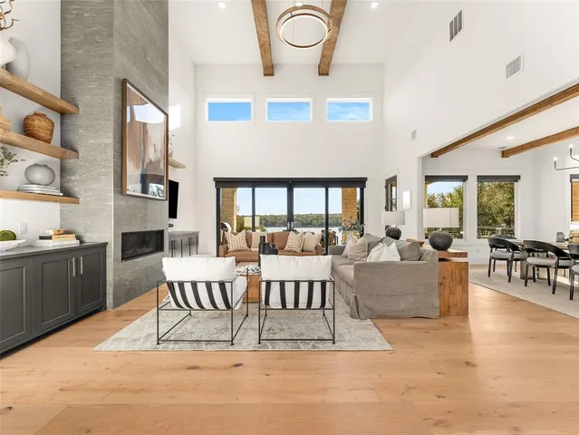 a living room with furniture wooden floor and window