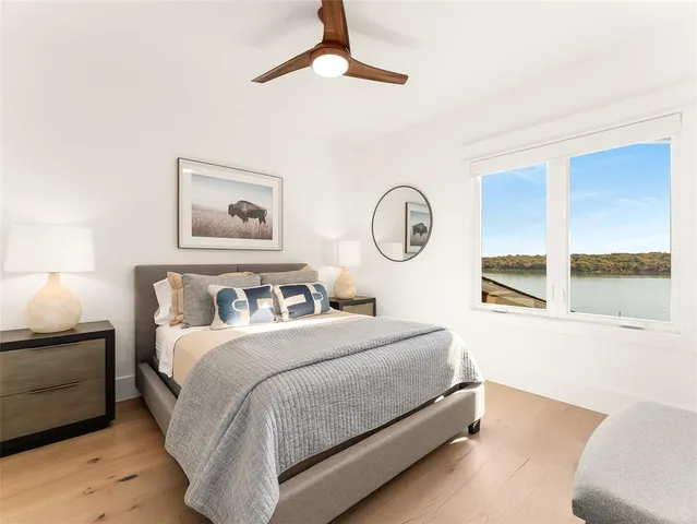 a bedroom with a bed and a painting on the wall