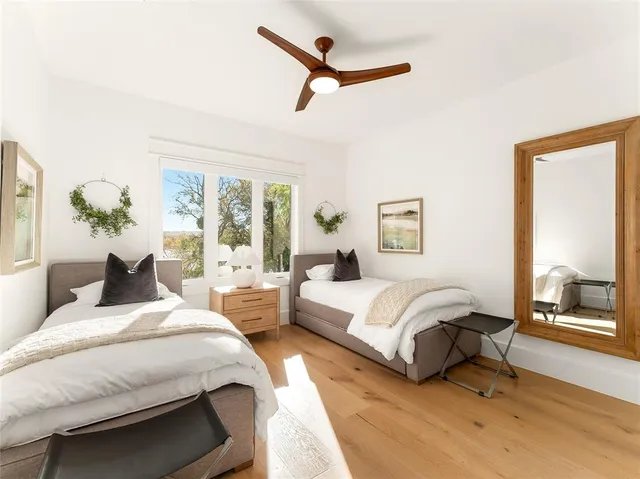 a bedroom with a large bed and a chandelier