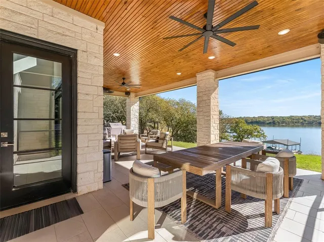 a view of a patio with table and chairs