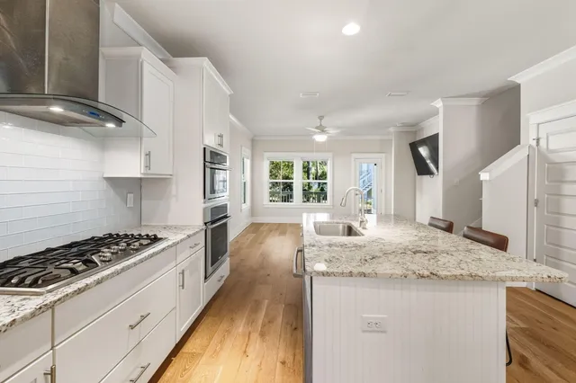 a view of kitchen with sink microwave and refrigerator