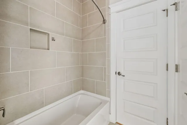 a view of a room with wooden floor and white walls
