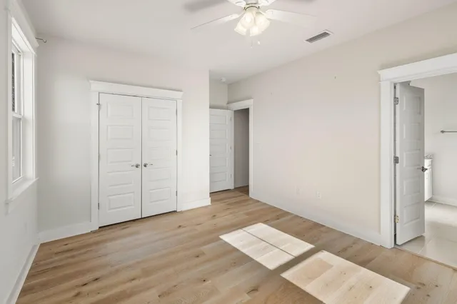 a view of walk in closet with wooden floor