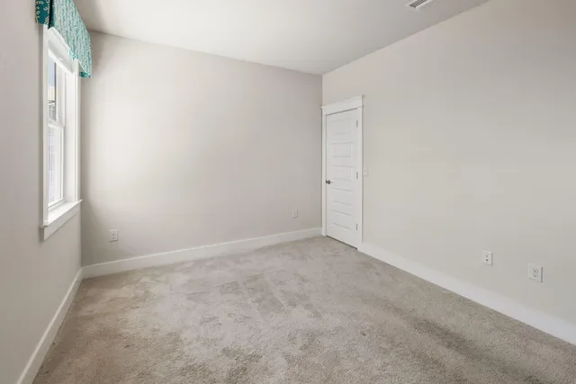 a view of a room with wooden floor and white walls