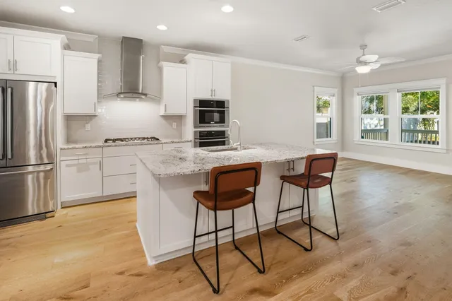 a kitchen with stainless steel appliances granite countertop a refrigerator oven stove a sink and dishwasher