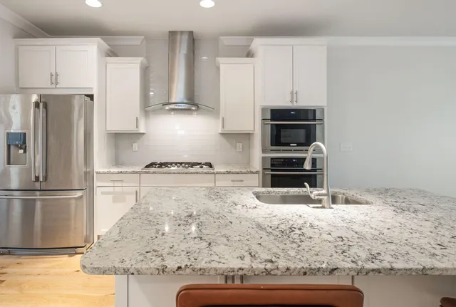 a view of kitchen with furniture and refrigerator