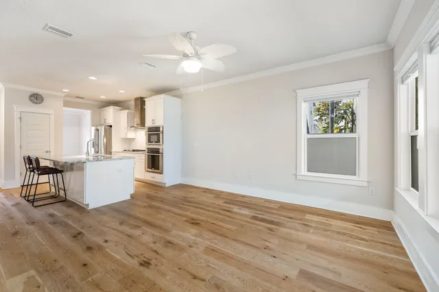 a view of a livingroom with wooden floor and a flat screen tv